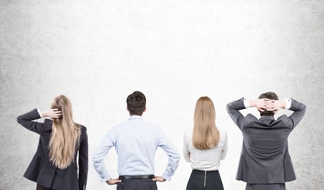 Businesspeople looking at concrete wall

Rear view of businesspeople in suits looking at a blank concrete wall. Concept of brainstorming. Mock up