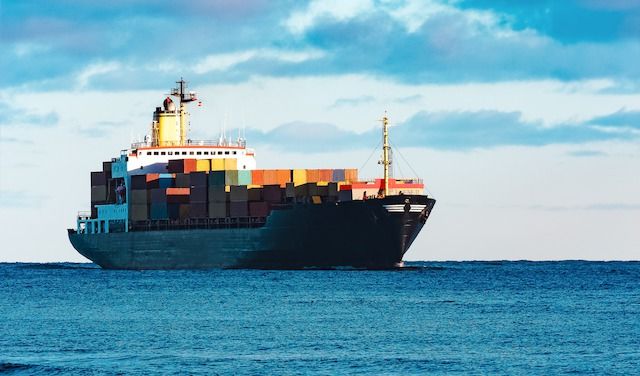 Modern black container ship moving from Baltic sea